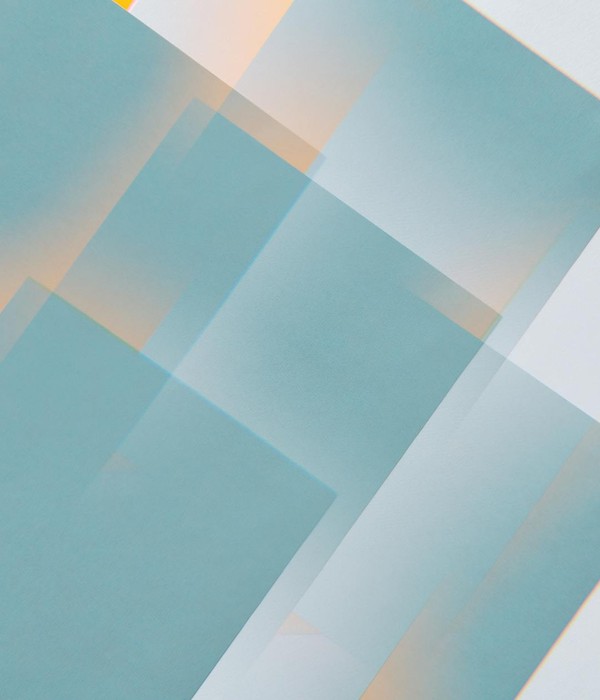 Creative abstract geometric design with overlapping teal and yellow rectangles.